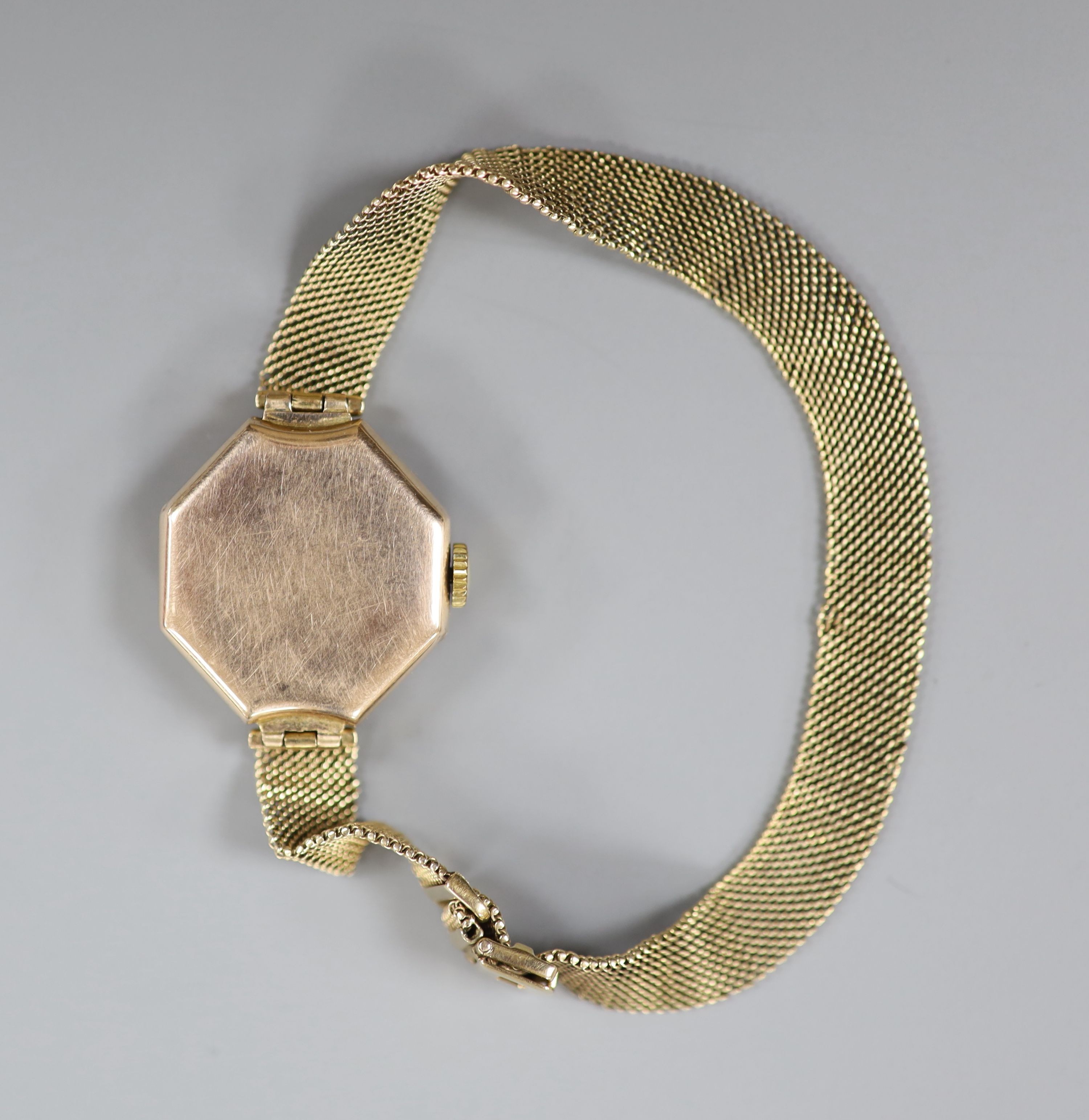 A lady's early 20th century yellow metal manual wind wrist watch, on a 9ct mesh link bracelet